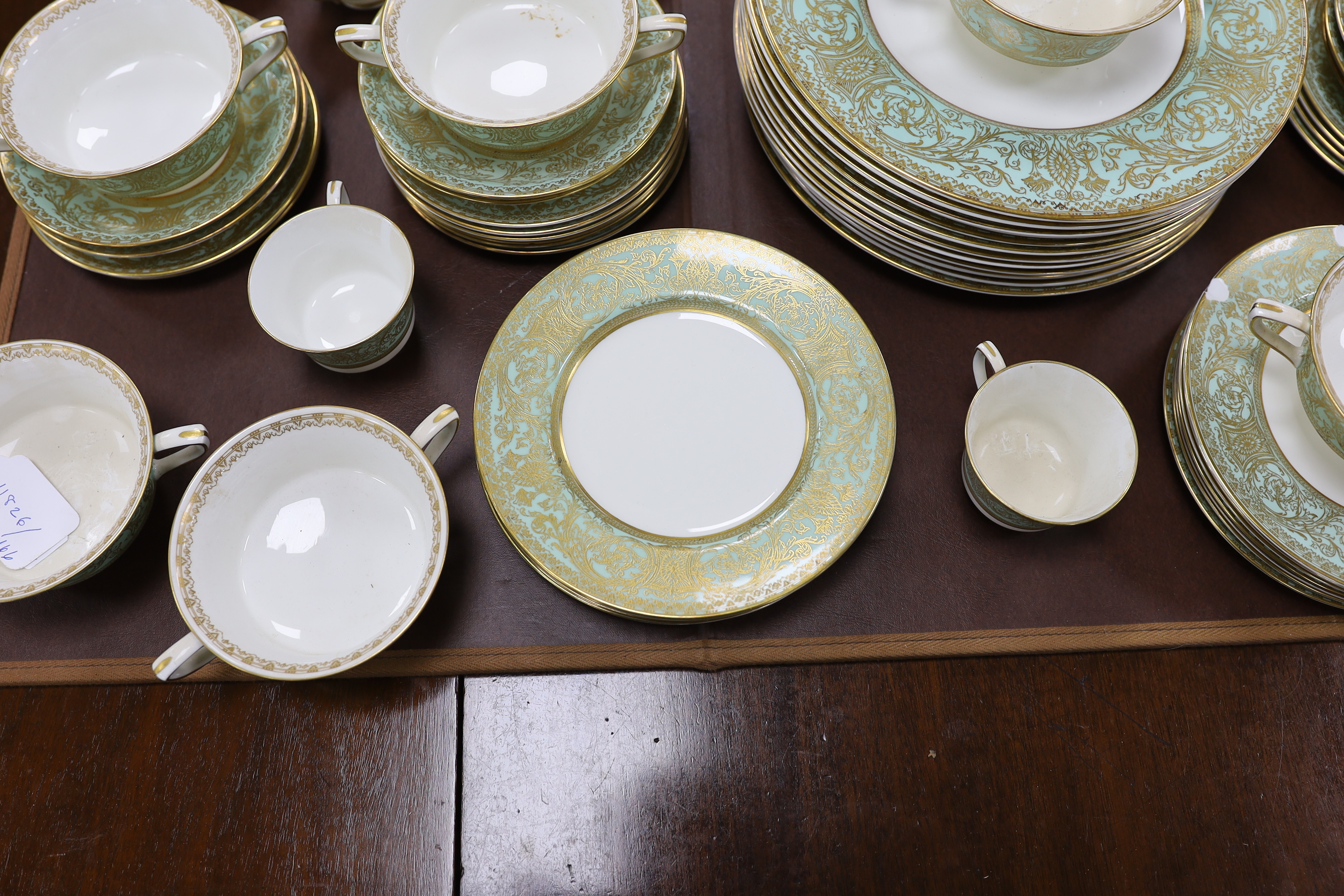 A Royal Worcester green and gilt decorated part dinner service